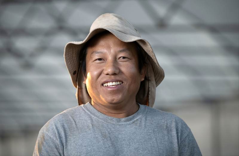 A smiling grower on their farm