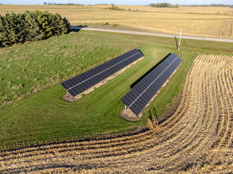 Solar panels installed at the edge of a farm field